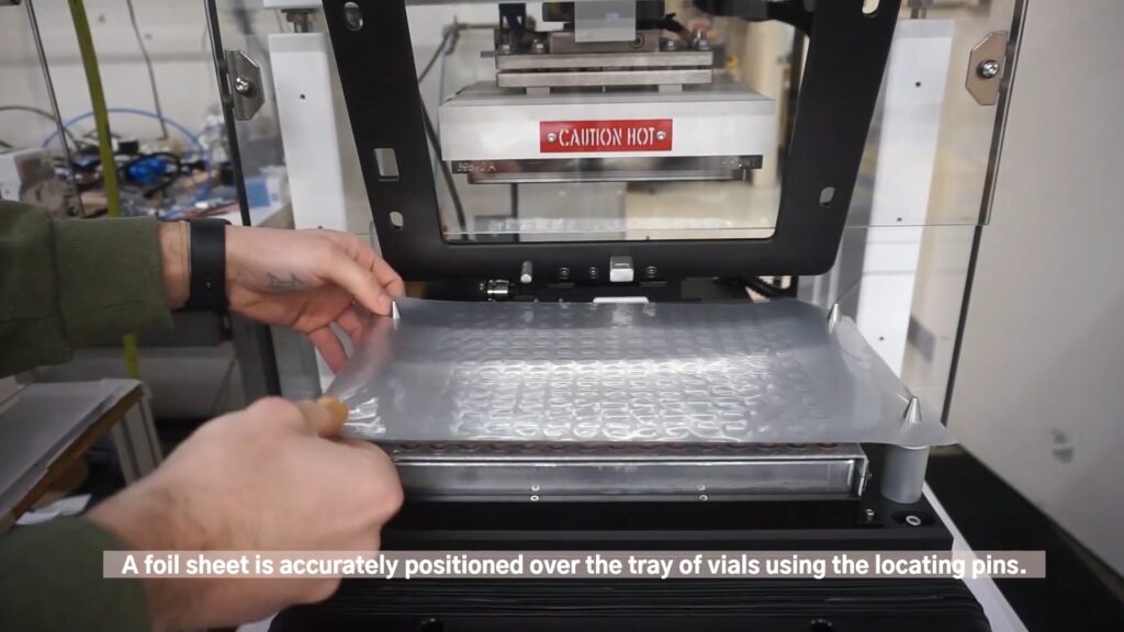 Foil sealing tray of vials on a Thermal Press machine