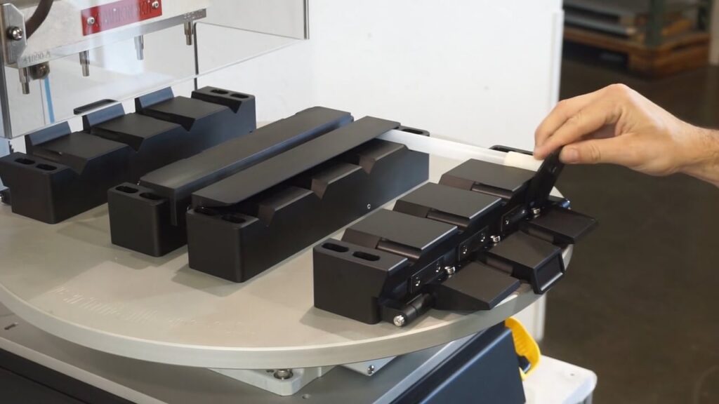 Loading parts onto customized fixture for heat staking on Thermal Press machine