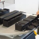 Loading parts onto customized fixture for heat staking on Thermal Press machine